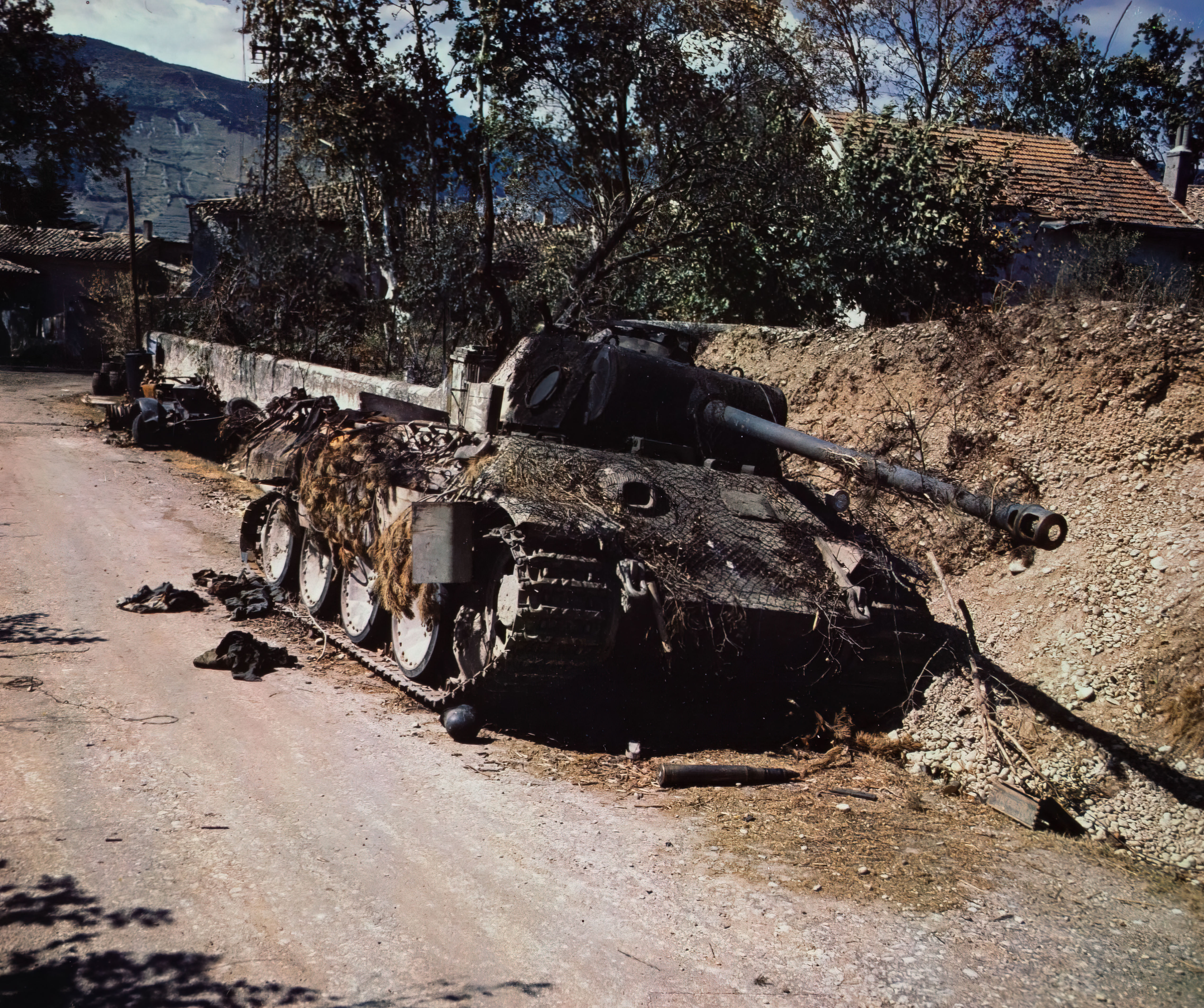 Knocked out and abandoned German tank on side of country road