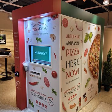 An indoor PizzaForno kiosk that serves pizza