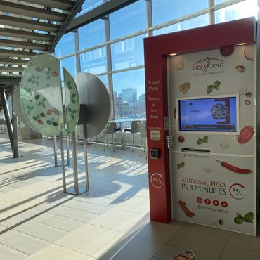 An indoor PizzaForno kiosk located inside a university