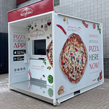 An outdoor pizza vending machine with snow beside it.