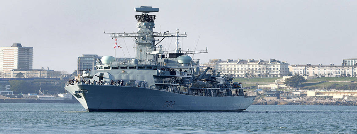 hms sheffield at sea with Plymouth in the background