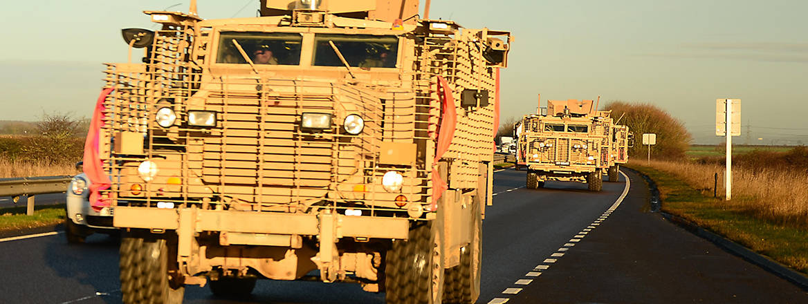 Military trucks driving in convoy