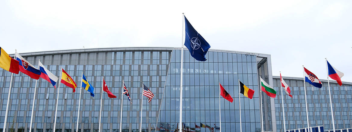 The national flags of countries member of the NATO fly outside the organisation headquarters in Brussels, Belgium. Image: Alexandros Michailidis / Alamy