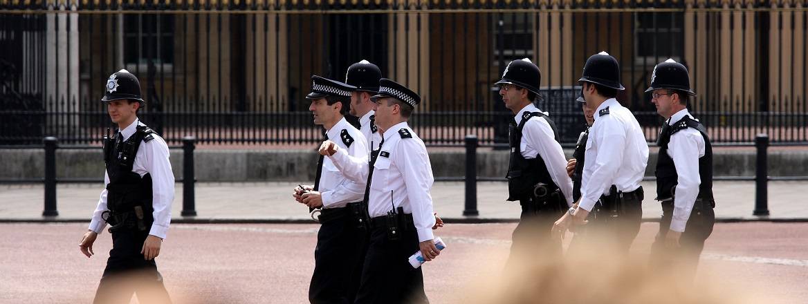 Police walk pass Buckingham Palace