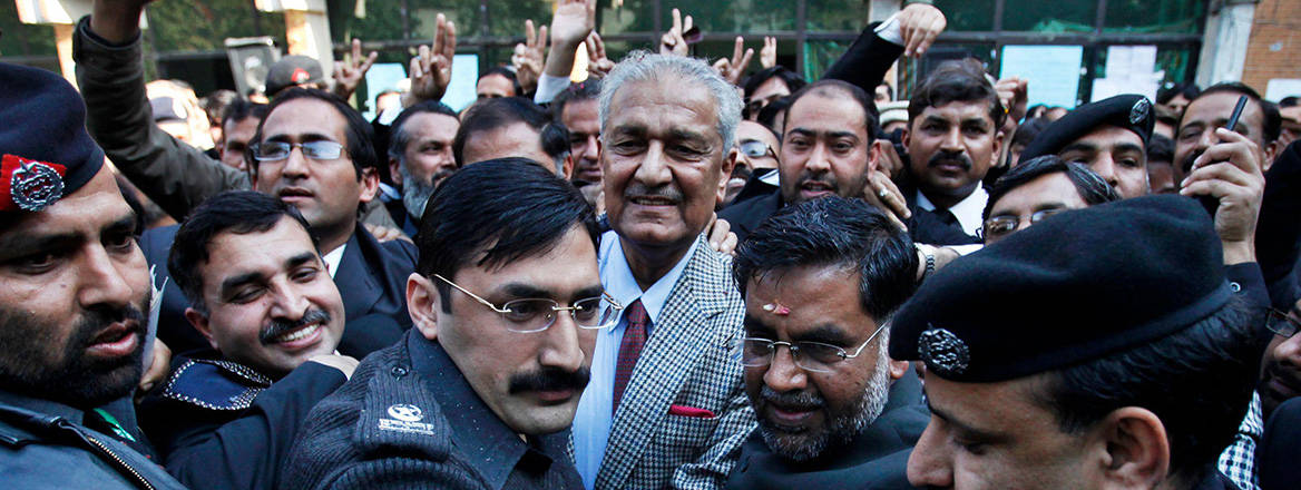 Pakistani nuclear scientist Abdul Qadeer Khan is surrounded by policemen and lawyers after addressing a convention in Rawalpindi, Pakistan in January 2010