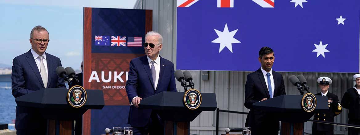 Anthony Albanese, Joe Biden and Rishi Sunak standing behind podiums