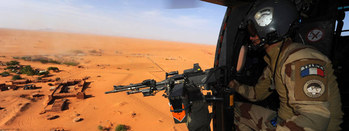 A French soldier participating in Operation Barkhane looks out over the desert in northern Niger