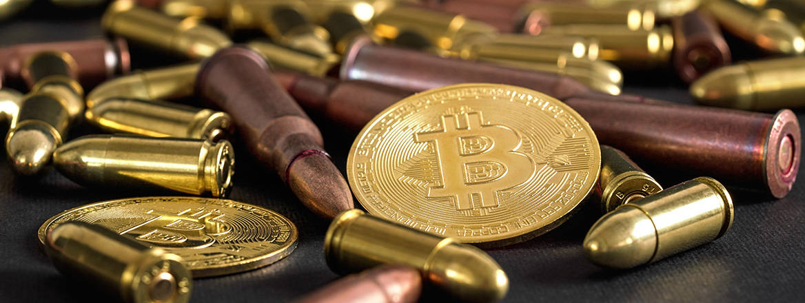 Bullets scattered on a table with bitcoins