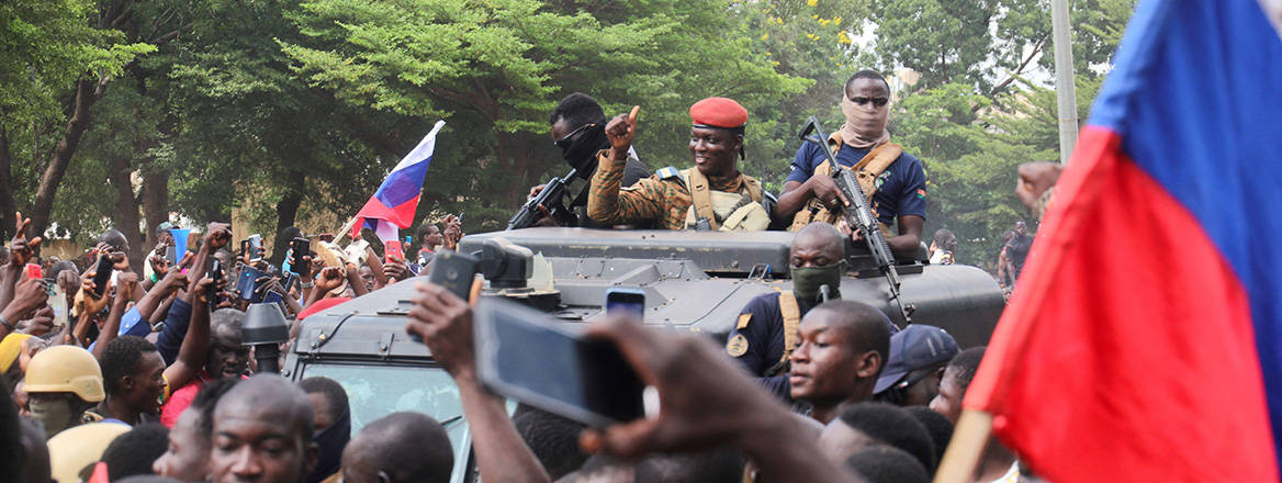 New bedfellows: the leader of Burkina Faso's October 2022 coup, Ibrahim Traore, is welcomed by supporters holding Russian flags