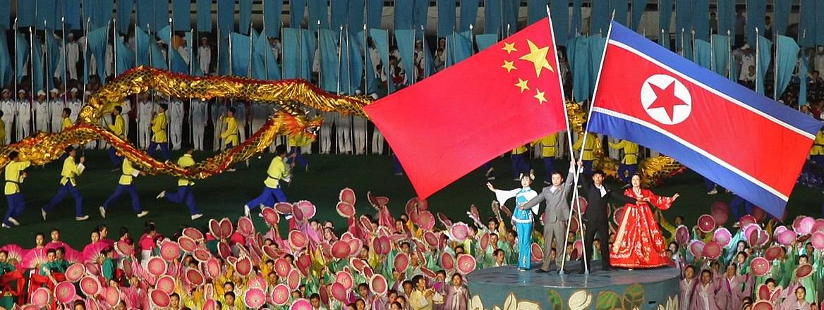 Chinese and North Korean flags at a ceremony