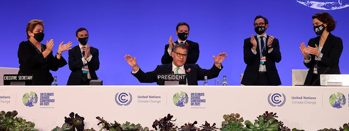 COP26 President Alok Sharma receives applause after the Glasgow Climate Pact is formally adopted. Courtesy of ukcop26.org / OGL v3.0