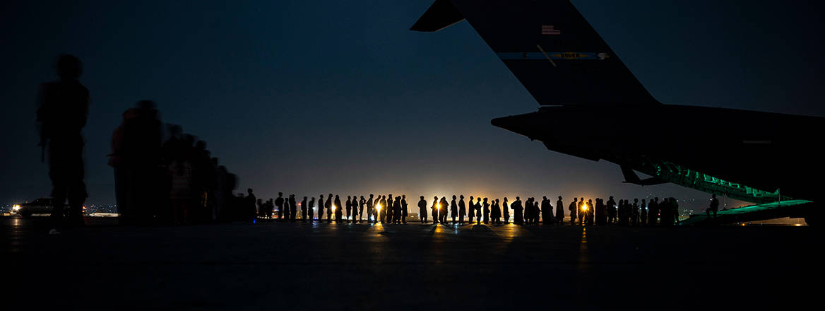 Final departure: evacuees queue to board a US Air Force plane at Kabul airport on 21 August 2021. Image: US Central Command Public Affairs