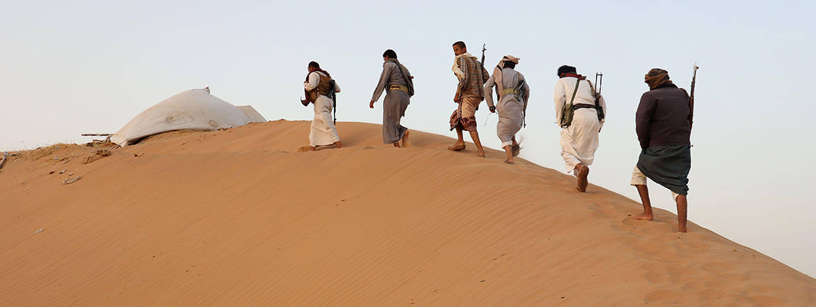 Armed men loyal to the Yemeni government guard a site near the Safer oil fields in Marib, Yemen, 12 September 2021