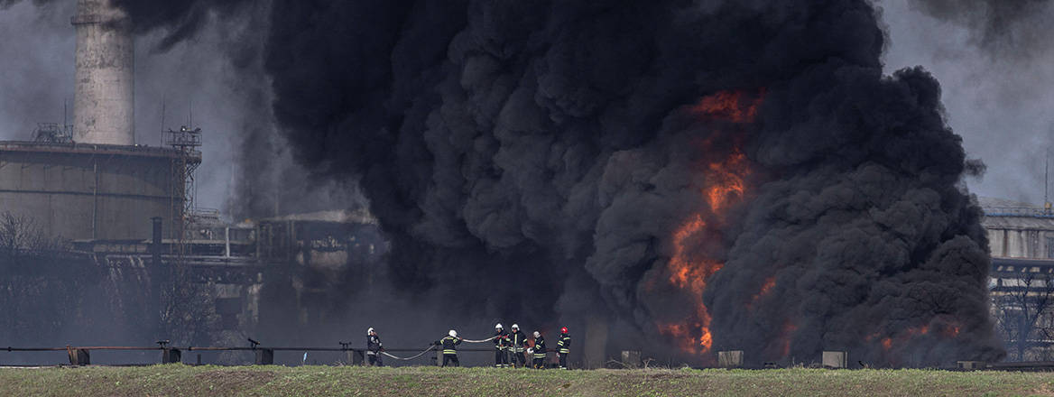Deadly clouds: firefighters work to put out a fire at an oil refinery in Lysychansk, Ukraine, after if was hit by a Russian missile. Image: Reuters / Alamy