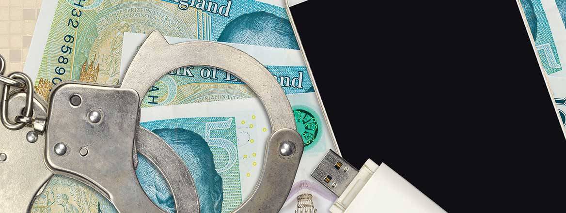 image showing five british pound notes, police handcuffs, smartphone and memory stick