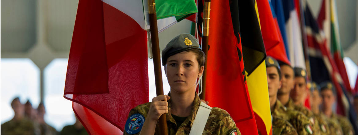 Italian air force airmen carry Allied and Partner Nations’ flags