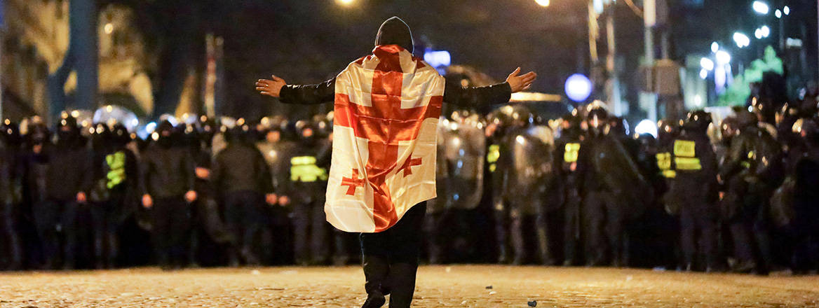 Making a stand: a protester walks toward police outside the Georgian parliament building in Tbilisi on 7 March 2023