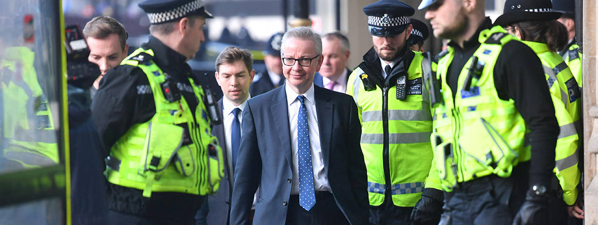 Ringing the changes: police officers escort Secretary of State for Levelling Up Michael Gove, who recently announced the new definition of extremism in the UK