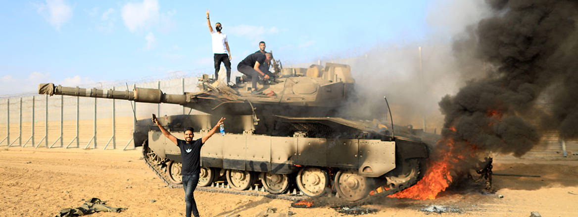 Breaking and entering: Hamas fighters set fire to an Israeli tank near the Gaza-Israel border on 7 October 2023