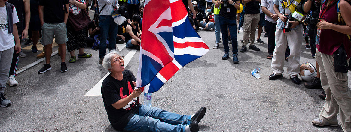 Betrayal: a protester waves a UK flag at the entrance of the LegCo complex in Hong Kong in 2019