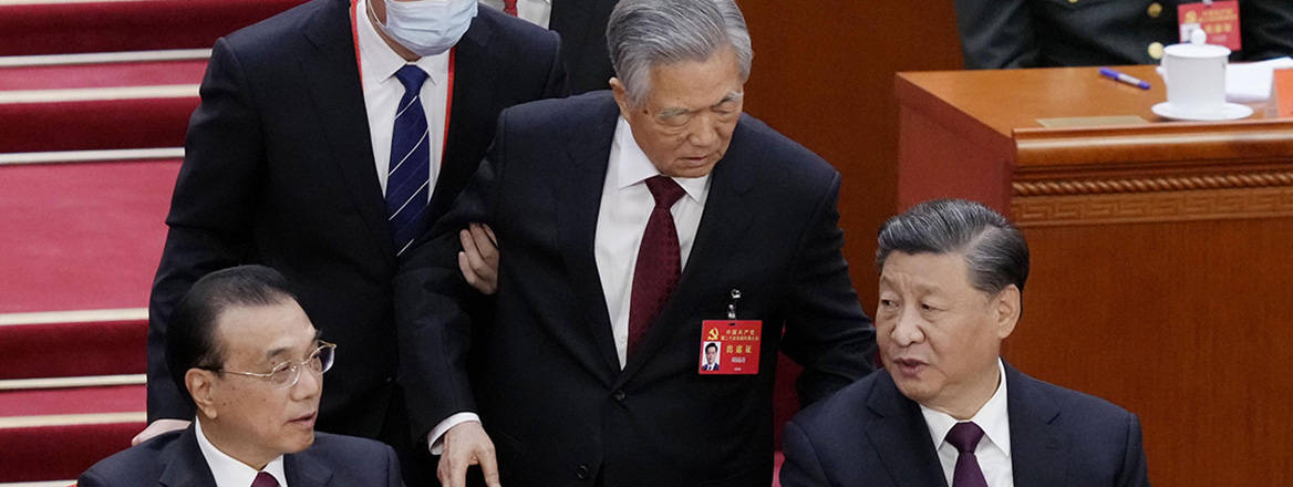 Political theatre: former Chinese President Hu Jintao is escorted out of the closing ceremony of the 20th National Congress of the Chinese Communist Party. Image: Newscom / Alamy
