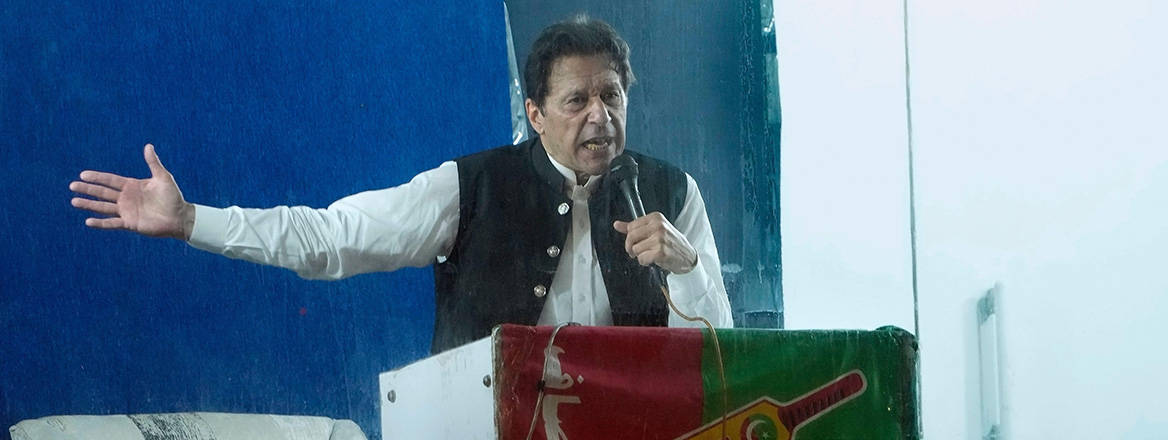 Bent on confrontation: former Pakistani Prime Minister Imran Khan speaks at a rally on 26 March, protected by a bulletproof barrier