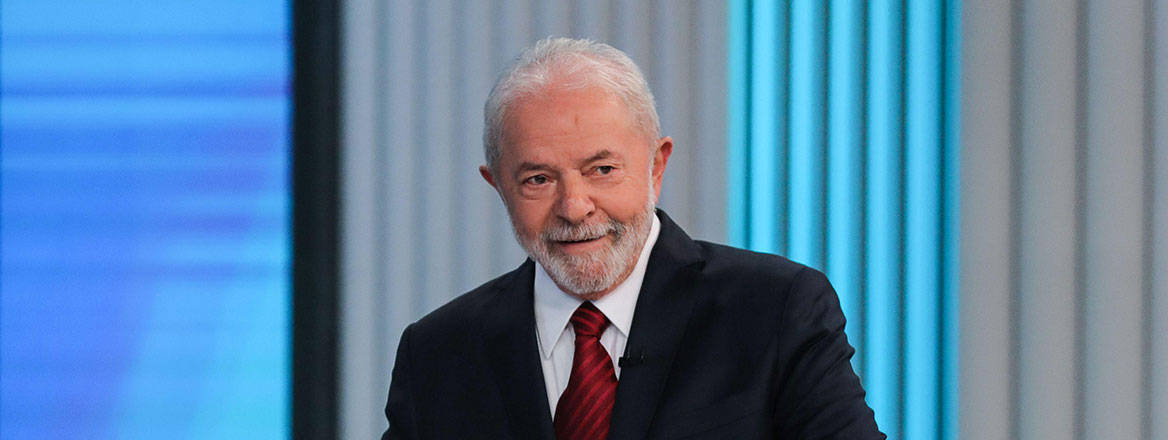 Lula da Silva wearing a suit with red tie.