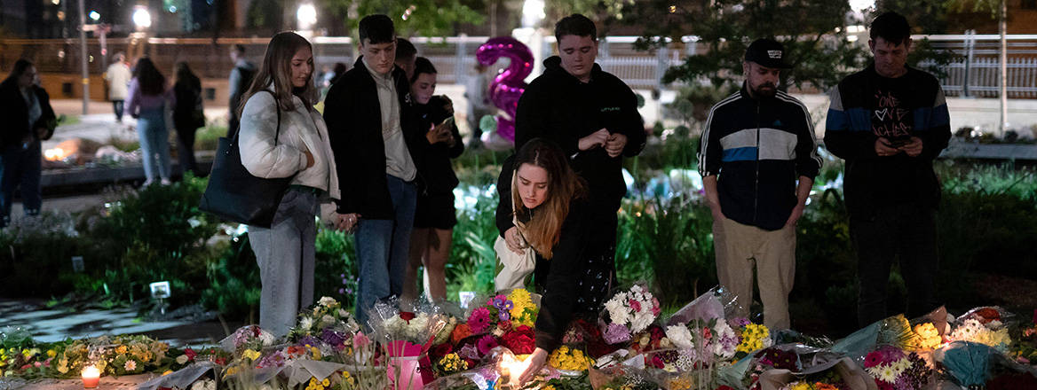 Five years on: members of the public gather at the Glade of Light memorial on 22 May 2022 to commemorate the victims of the 2017 terrorist attack at Manchester Arena. Jon Super / Alamy