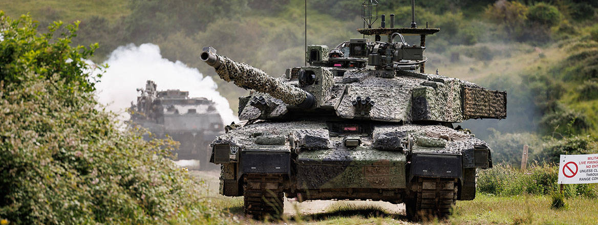 The Megatron variant of the Challenger 2 tank storms down a track on Lulworth Range during a rehearsal demonstration