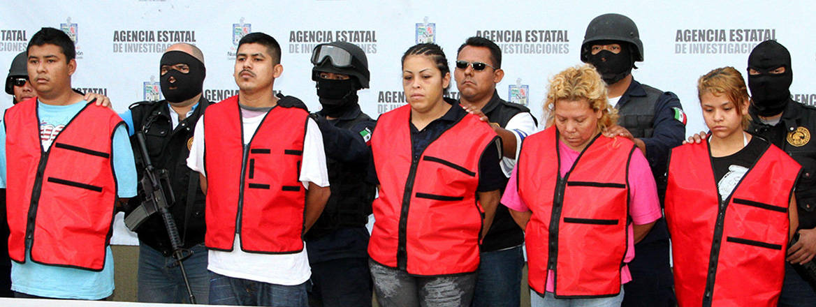 Complex dynamics: the leader of a Mexican gang, Maria Jimenez, pictured along with fellow gang members after their capture by authorities in 2012