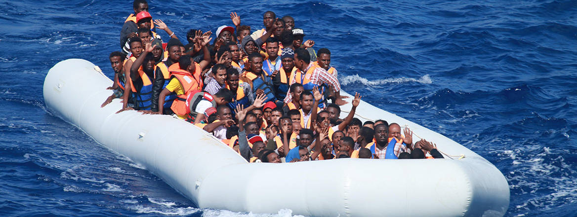 Desperate voyage: migrants in an inflatable boat attempting to cross the Mediterranean from Libya. Image: US Navy / Wikimedia Commons