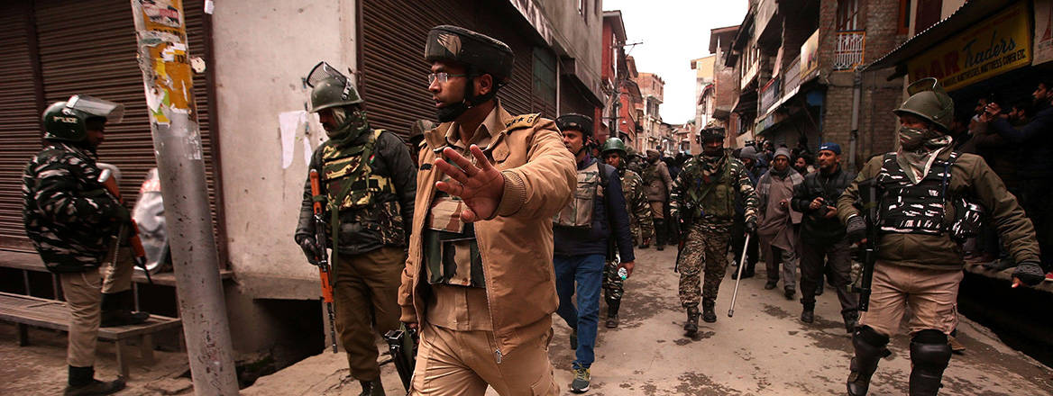 Indian police and National Investigation Agency officials leave after carrying out a raid at the home of a Kashmiri activist on supposed counterterrorism financing grounds