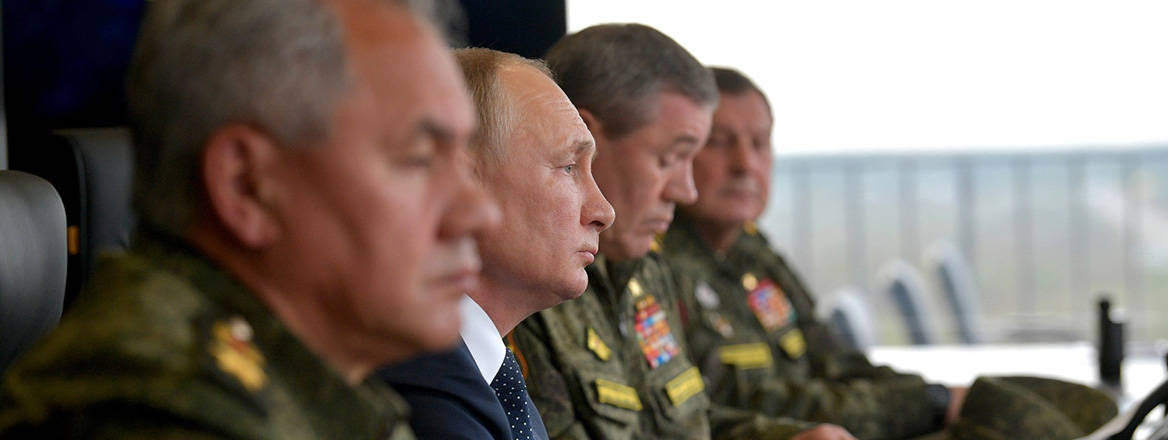 President Vladimir Putin flanked by Defence Minister Sergei Shoigu and generals