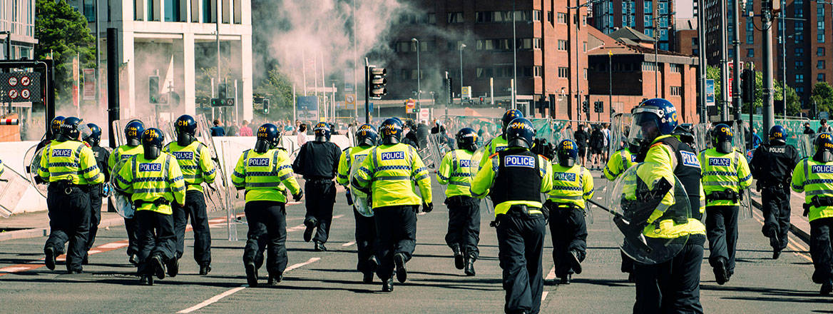 Holding the line: police face off against far-right rioters in Liverpool on 3 August 2024