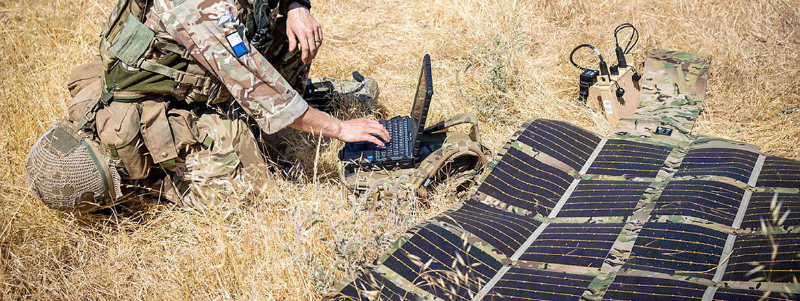 Fragile supply: a British soldier uses a portable solar panel device during training exercises