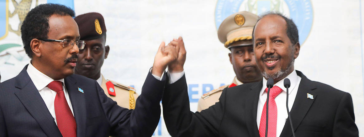 Peaceful handover: Somalia's new president Hassan Sheikh Mohamud hold hands with former president Mohamed Abdullahi Mohamed 'Farmaajo' after winning the country's elections on 16 May 2022. Image: Reuters / Alamy