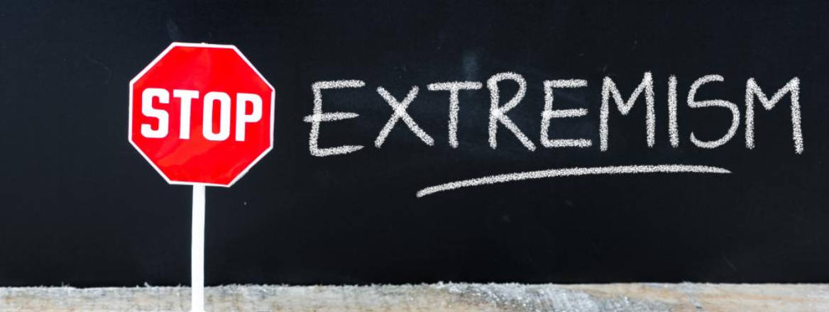 stop sign with written extremism on chalk board