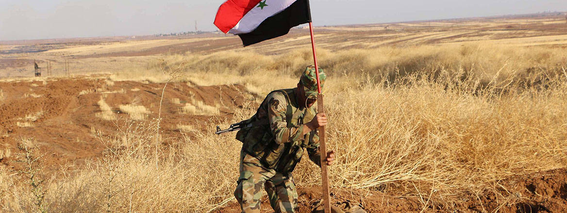Changing hands: a Syrian soldier plants the national flag in an oil field in November 2019. The Wagner Group previously had extensive involvement in Syria's oil and gas sector