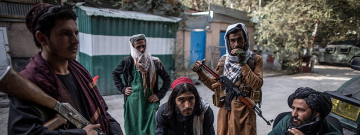 A group of Talbian fighters, some holding weapons, facing the camera