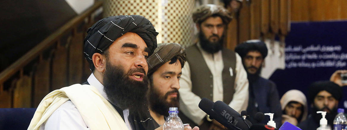 Taliban spokesman Zabihullah Mujahid speaking to the media on 17 August 2021 in Kabul. Courtesy of Newscom/Alamy Stock Photo