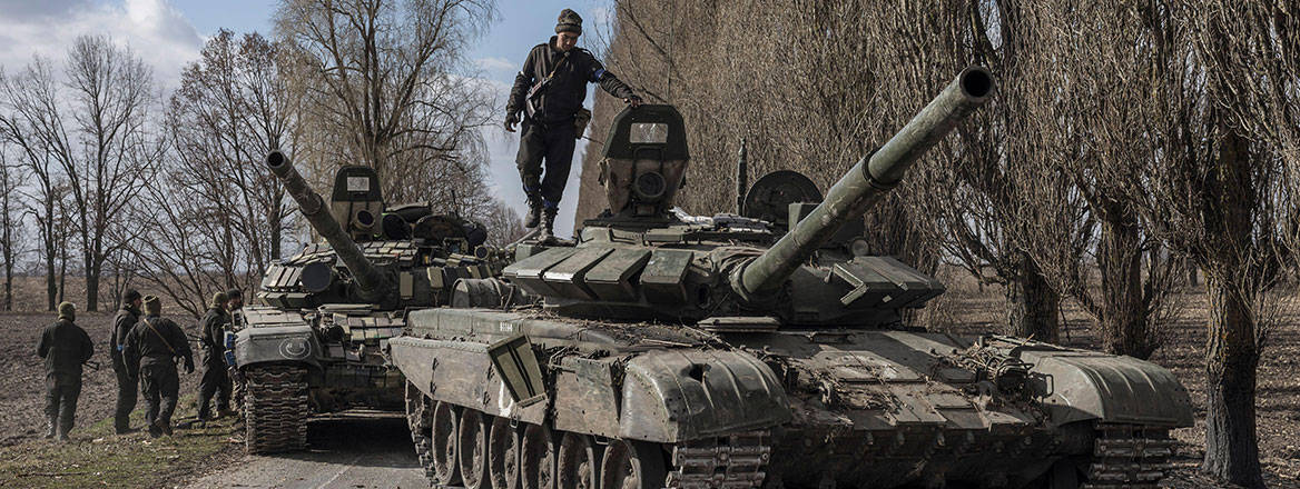 A Ukrainian serviceman stands on top of a Russian tank captured after fighting with Russian troops near Kyiv, 27 March 2022. Courtesy of Reuters / Alamy Stock Photo