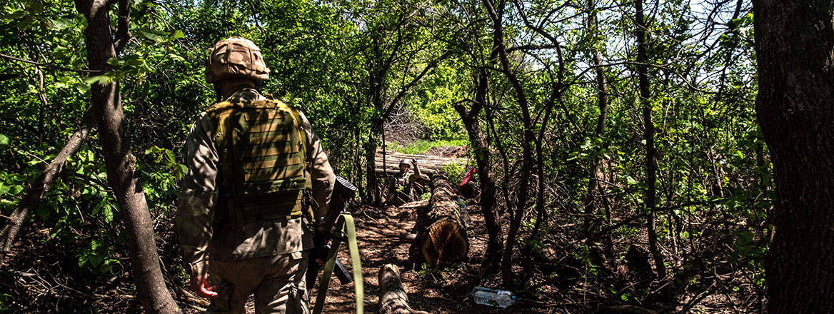 Green screen: a Ukrainian soldier walks through a forest near the frontline in the Dnipro region