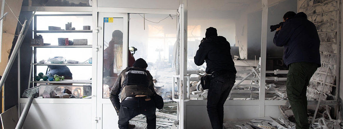 On the front line: reporters filming a bombed-out building in Kyiv, Ukraine on 2 March 2022