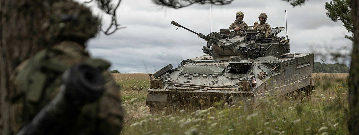Challenges ahead: a Warrior armoured vehicle moves across Salisbury Plain Training Area in Wiltshire