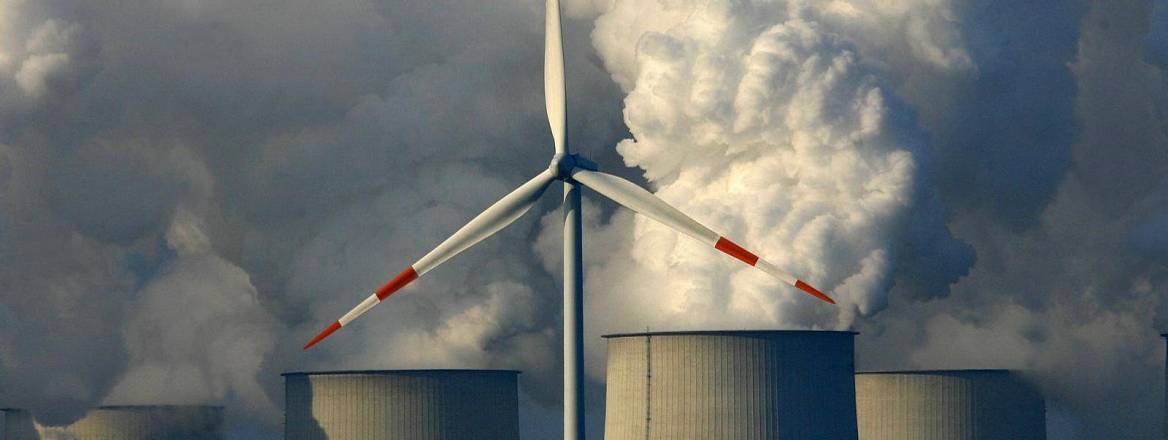 A wind turbine in front of the lignite-fired power plant in Jänschwalde, Germany, 2007.