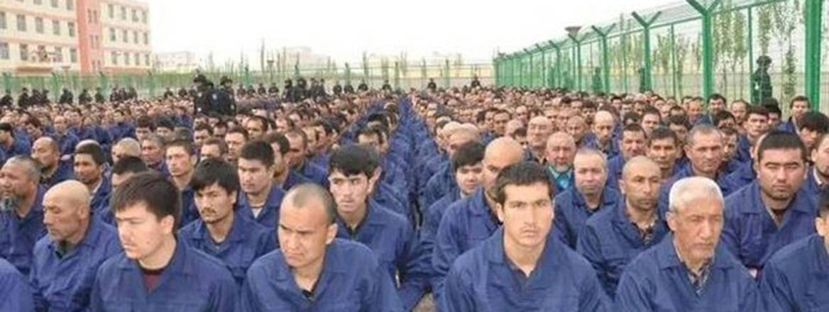 Uyghur detainees listening to a 'de-radicalisation' speech at a camp in Lop county, Xinjiang, April 2017