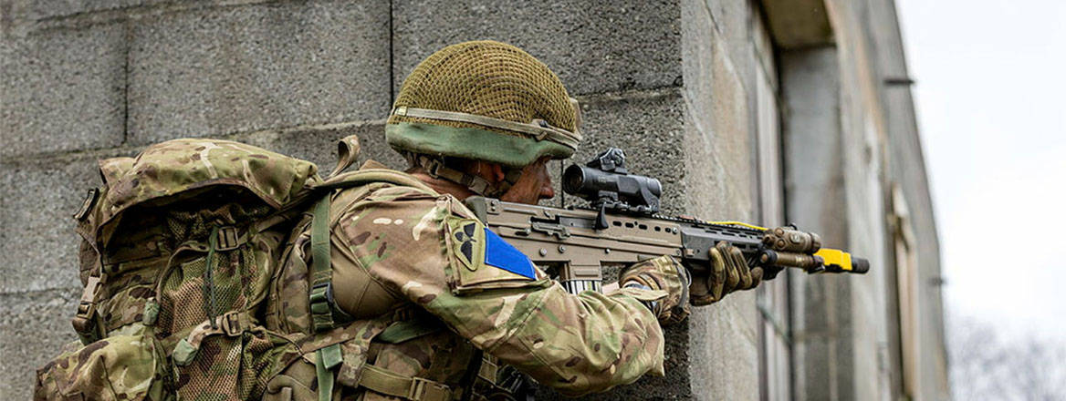 A 2nd Battalion, Parachute Regiment soldier holds position with his rifle at the corner of a building as part of Exercise Orion, 2025. 