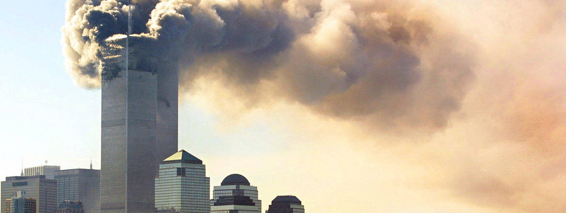 Clouds of smoke rise from the burning upper floors just before the Twin Towers of the World Trade Center in New York collapse, 11 September 2001.