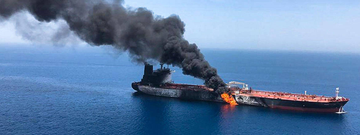 Oil tanker on fire in the sea of Oman. Courtesy of AP/Alamy