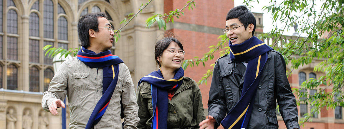 A group of Chinese students walk across the campus at the University of Birmingham, England, UK.